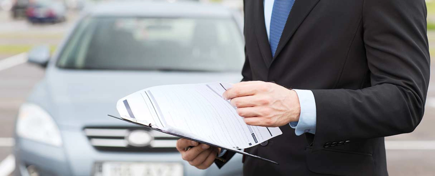 hero auto insurance man infront of car paperwork tyler tx